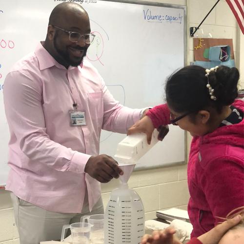 Anthony Swann, 2021 Virginia Teacher of the Year with a student