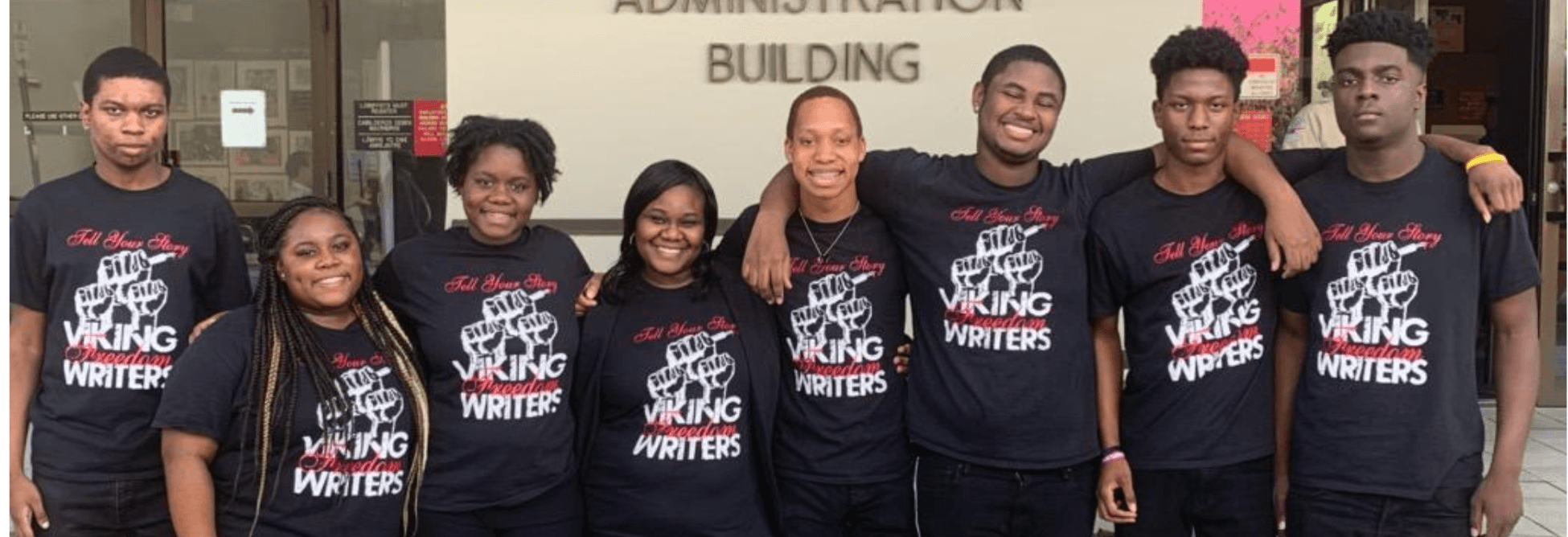 Dr. Symonette posing with several students all wearing shirts that say Viking Freedom Writers
